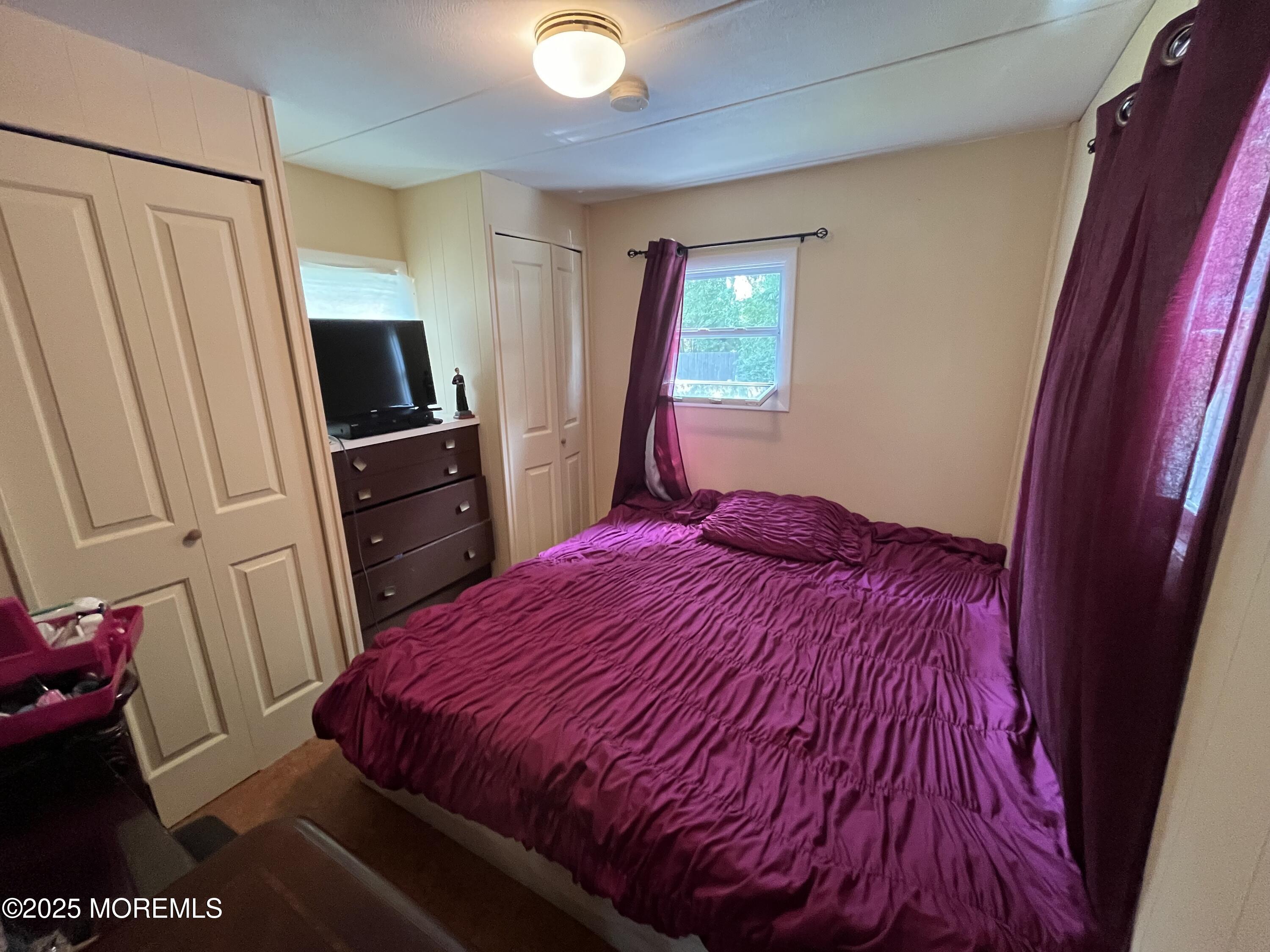 7 Grace Lane Howell, NJ 07731 - Photo 8 of 15 a bedroom with a bed and a flat tv screen on dresser