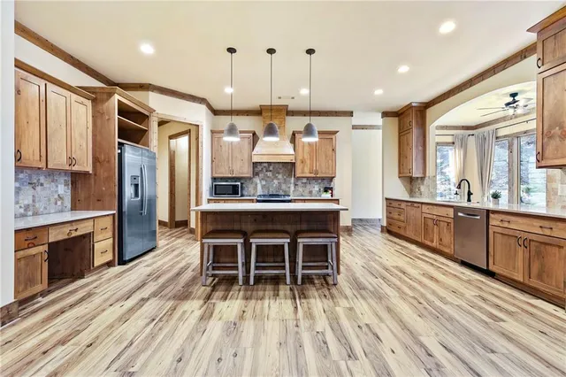 a large kitchen with a table and chairs