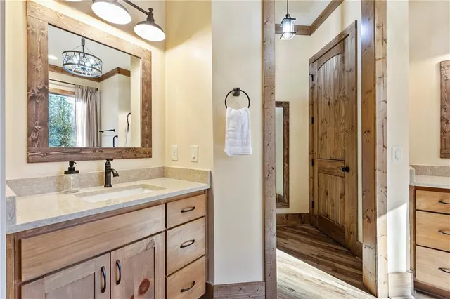 a bathroom with a tub sink and mirror
