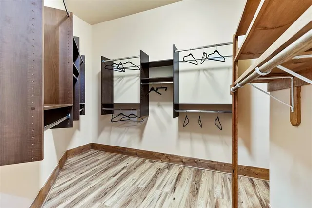 a view of a livingroom with wooden floor and closet