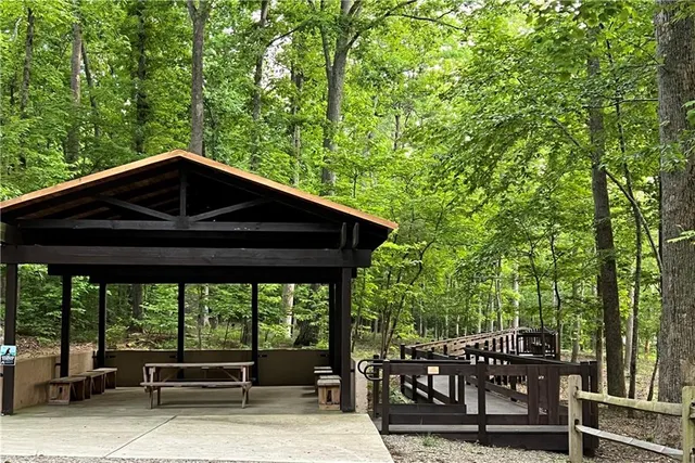 a front view of a house with a tree