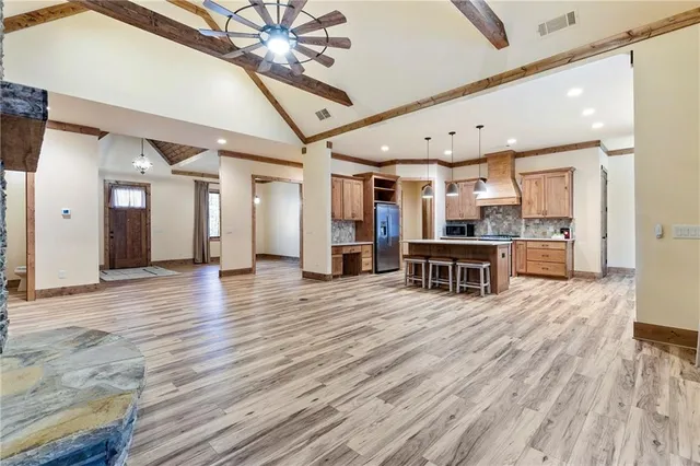 a view of a room with wooden floor and ceiling fan