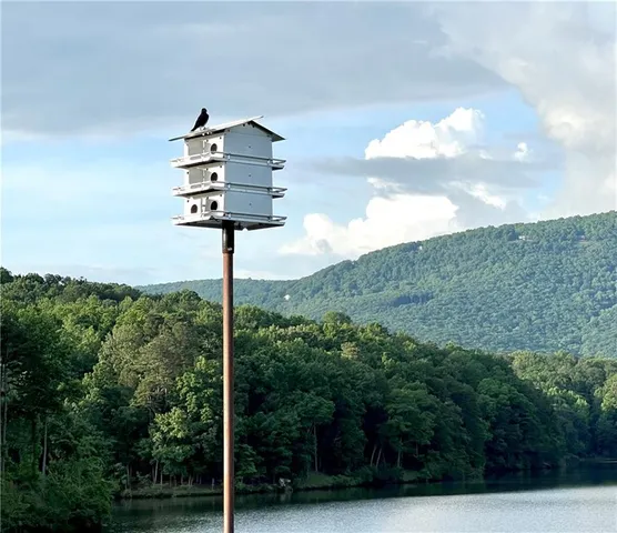 a backyard of a house with table and chairs wooden fence