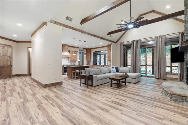 a living room with furniture and a chandelier