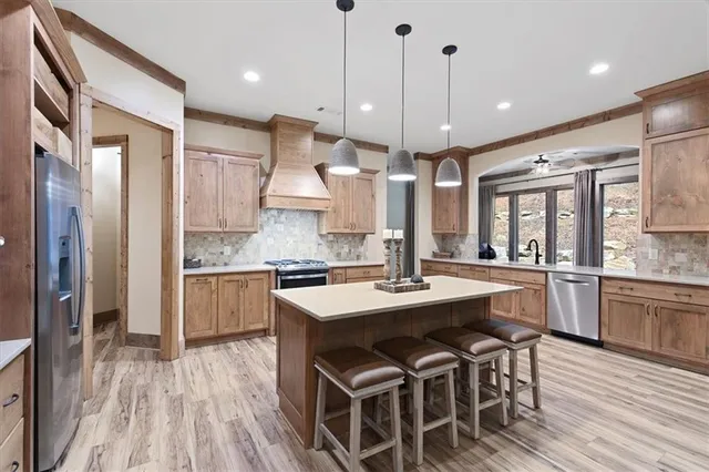 a large kitchen with a table and chairs
