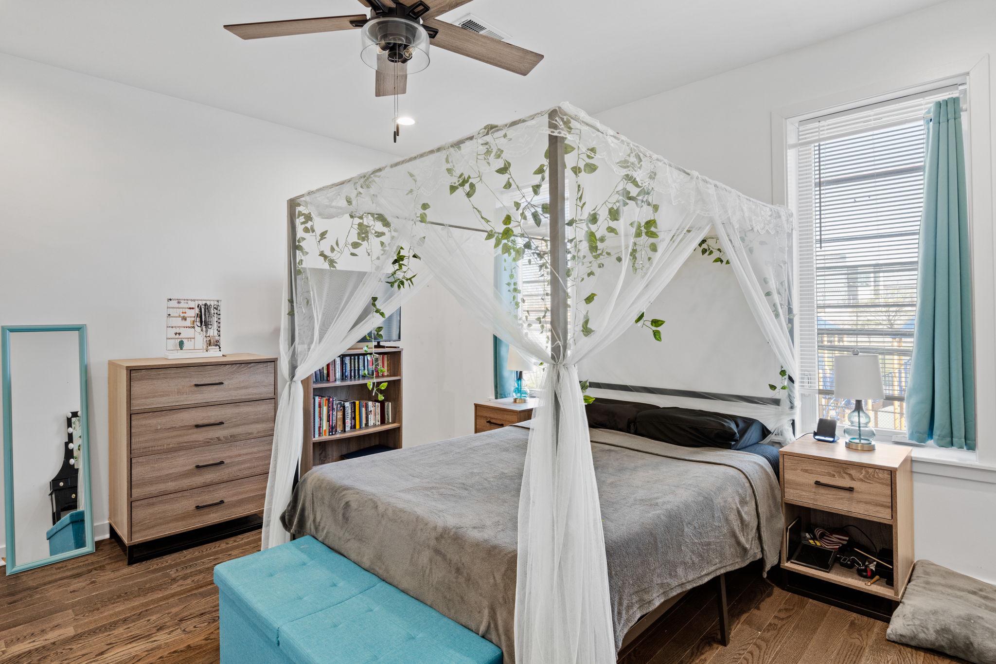 2924 Wharton Street Philadelphia, PA 19146 - Photo 12 of 29 a bedroom with a bed and a chandelier