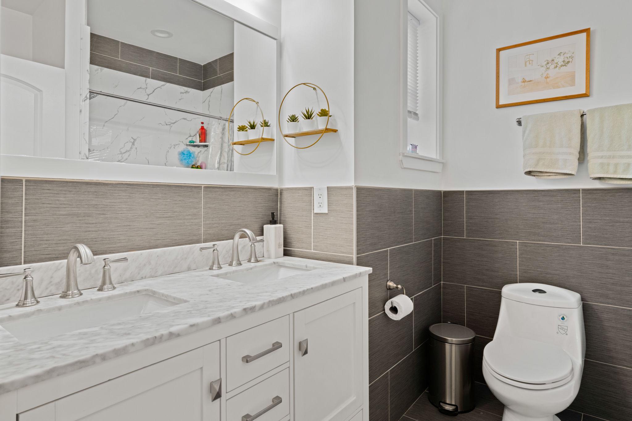 2924 Wharton Street Philadelphia, PA 19146 - Photo 19 of 29 a bathroom with a granite countertop sink mirror vanity and toilet