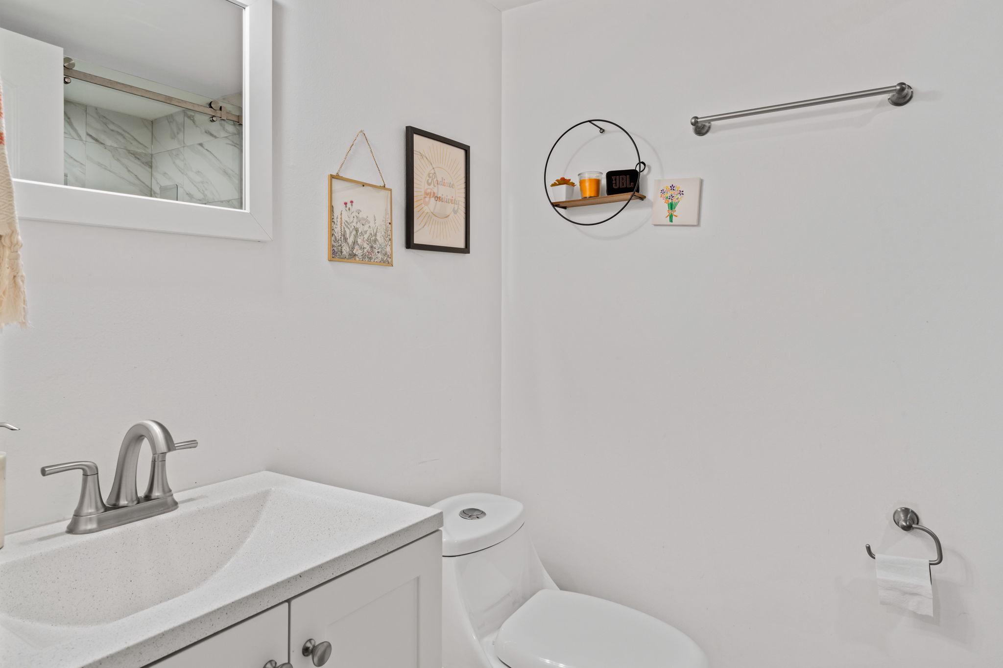 2924 Wharton Street Philadelphia, PA 19146 - Photo 24 of 29 a bathroom with a toilet sink vanity and mirror