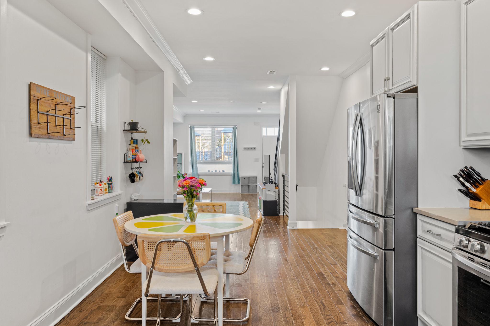 2924 Wharton Street Philadelphia, PA 19146 - Photo 5 of 29 a kitchen with stainless steel appliances a dining table chairs refrigerator and stove