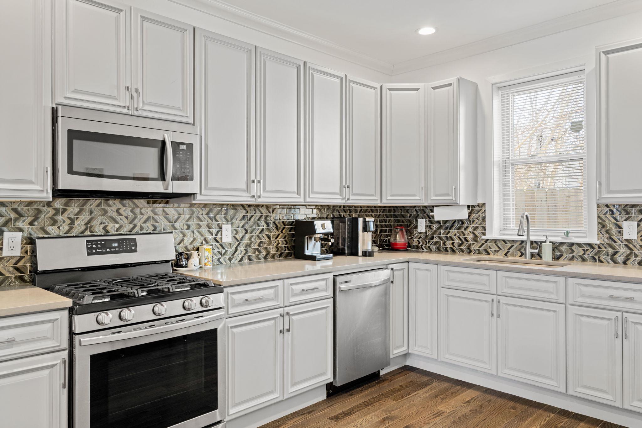 2924 Wharton Street Philadelphia, PA 19146 - Photo 8 of 29 a kitchen with cabinets appliances and a window