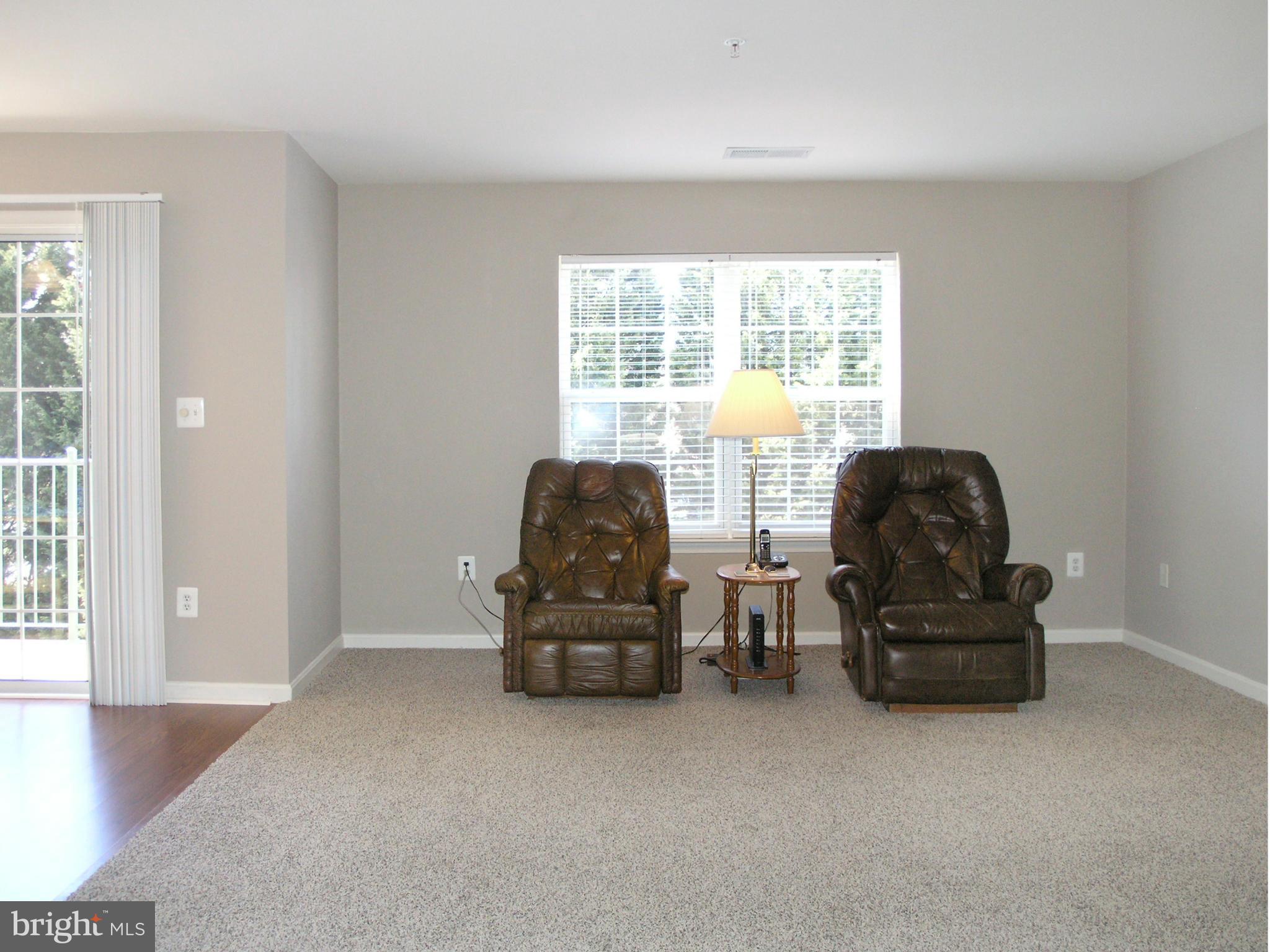 11894 Breton Court, Unit 7B Reston, VA 20191 - Photo 14 of 30 a living room with furniture and a window
