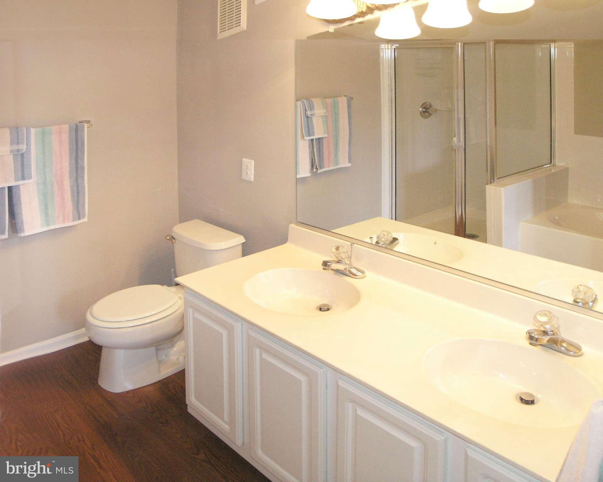 11894 Breton Court, Unit 7B Reston, VA 20191 - Photo 23 of 30 a bathroom with a sink and a mirror