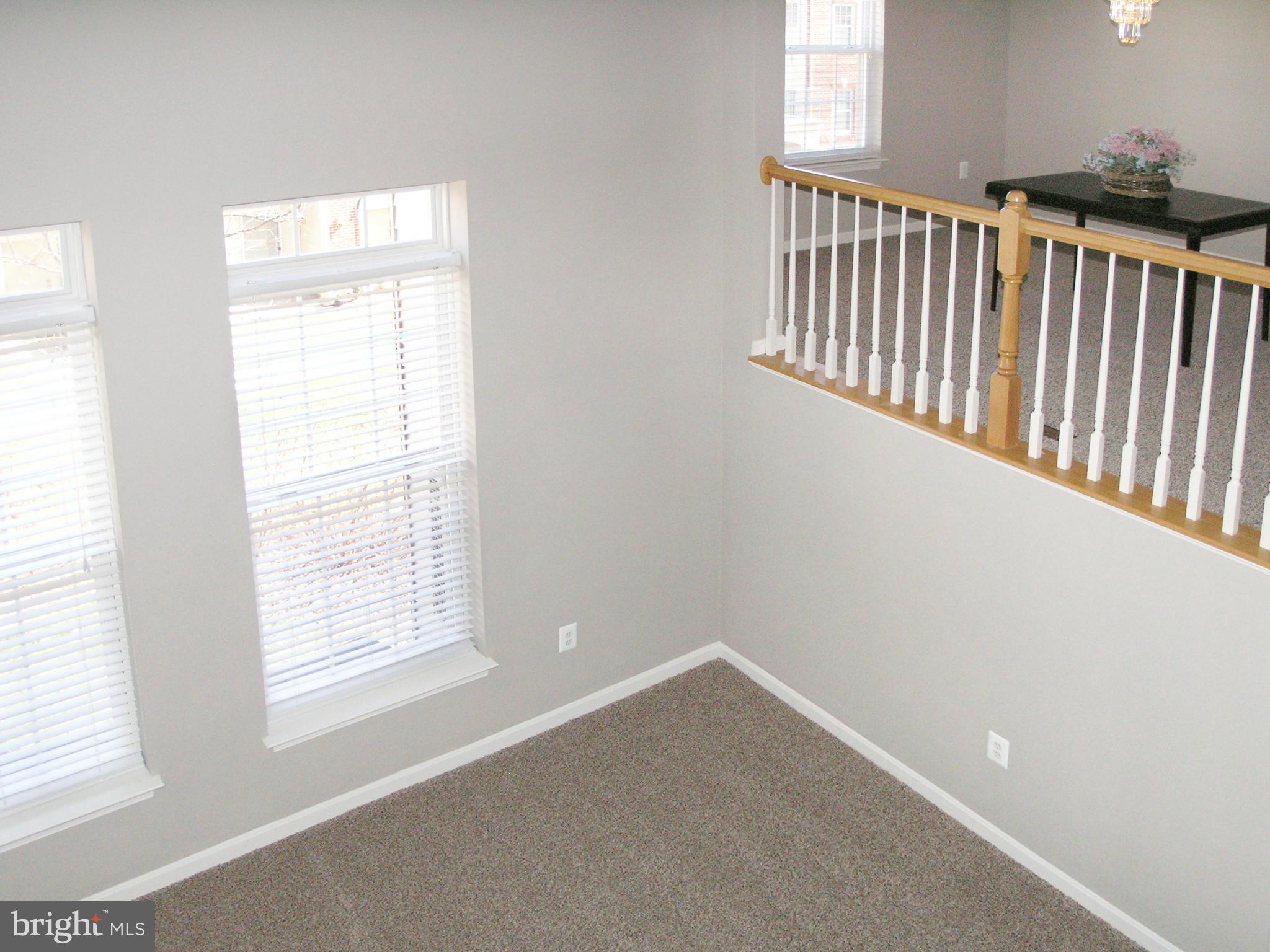 11894 Breton Court, Unit 7B Reston, VA 20191 - Photo 6 of 30 an empty room with windows