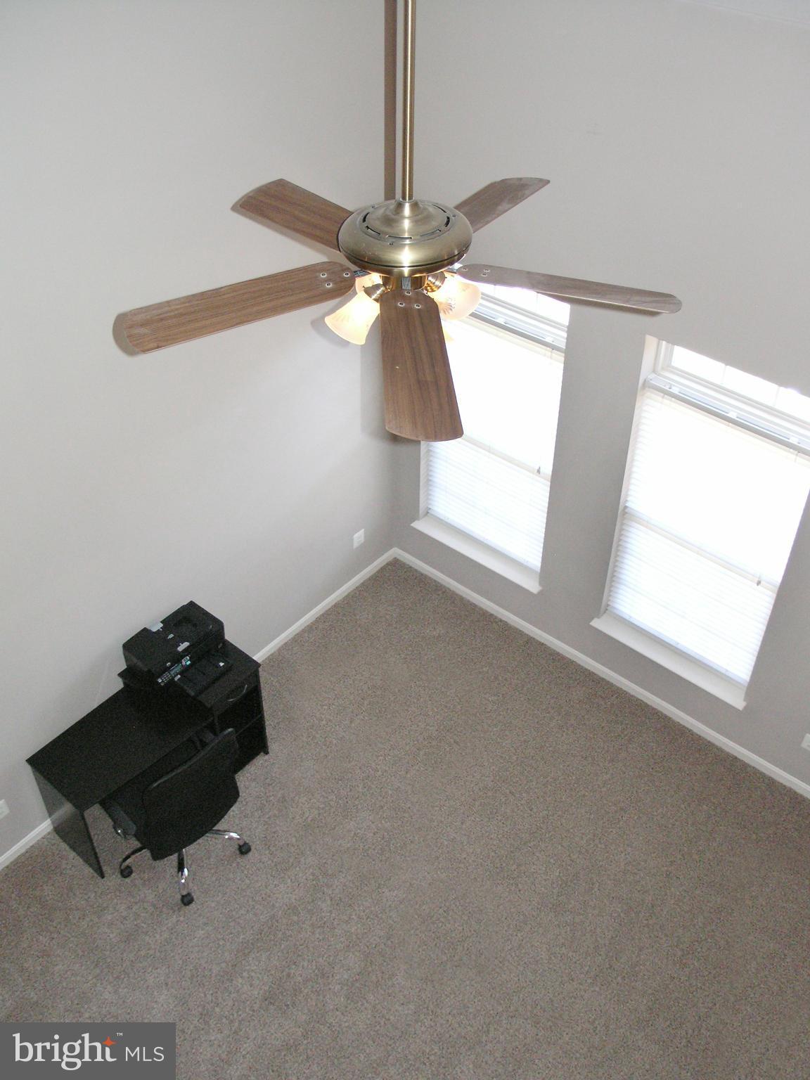 11894 Breton Court, Unit 7B Reston, VA 20191 - Photo 9 of 30 a room with a window and a chandelier fan