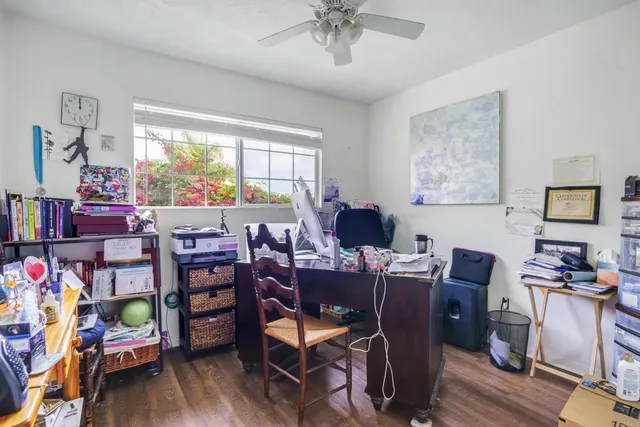 a view of a workspace with furniture and a window
