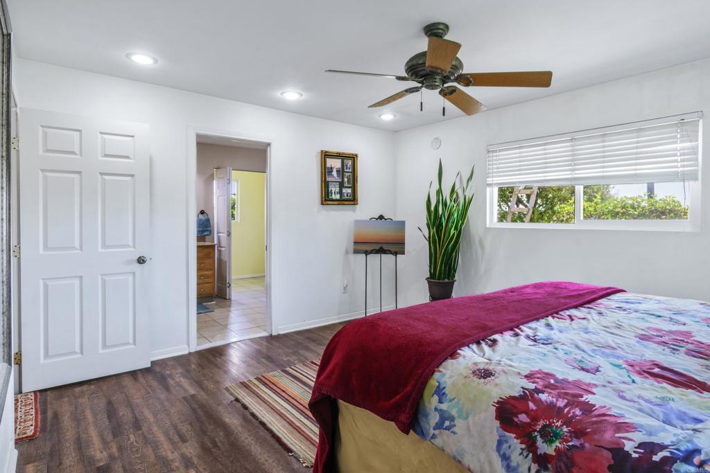 306 Fowles Street Oceanside, CA 92054 - Photo 15 of 29 a bedroom with a bed and a chandelier