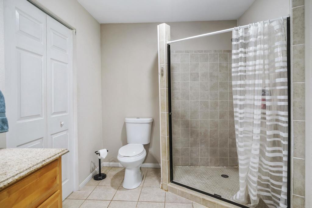 306 Fowles Street Oceanside, CA 92054 - Photo 20 of 29 a bathroom with a granite countertop shower a toilet and a sink