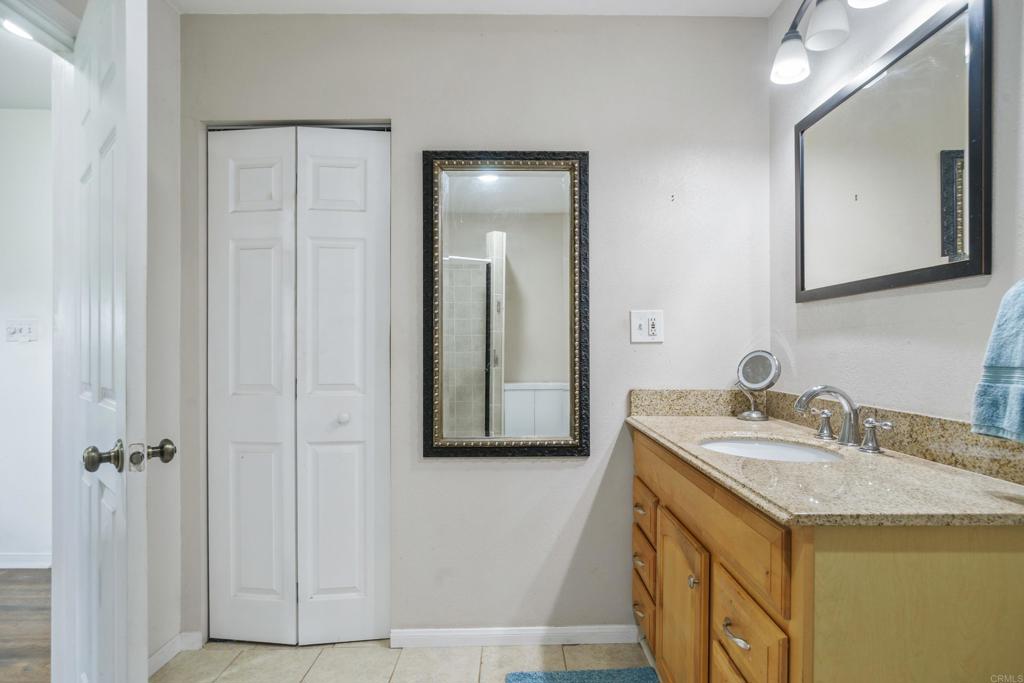 306 Fowles Street Oceanside, CA 92054 - Photo 21 of 29 a bathroom with a granite countertop sink and a mirror