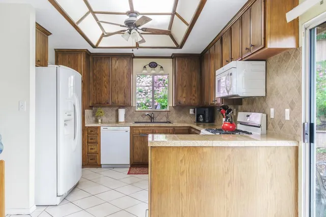 a kitchen with a refrigerator a sink and dishwasher