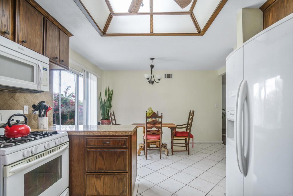 306 Fowles Street Oceanside, CA 92054 - Photo 8 of 29 a kitchen with stainless steel appliances granite countertop a refrigerator and a stove top oven