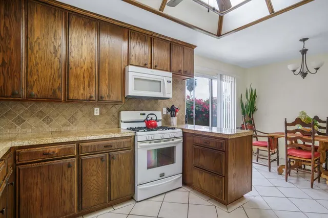 a kitchen with stainless steel appliances granite countertop a stove and cabinets