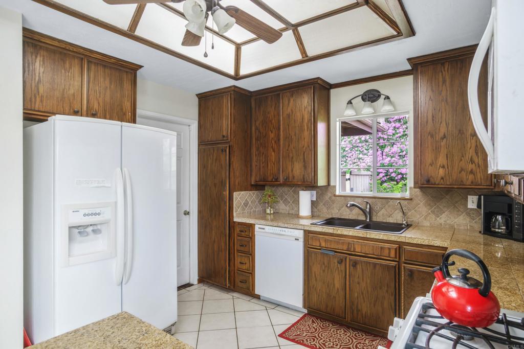 306 Fowles Street Oceanside, CA 92054 - Photo 10 of 29 a kitchen with stainless steel appliances granite countertop a refrigerator sink and cabinets