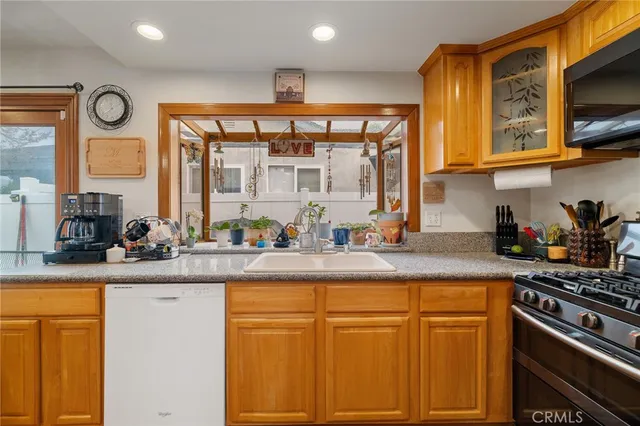 a kitchen with stainless steel appliances granite countertop a stove and a sink