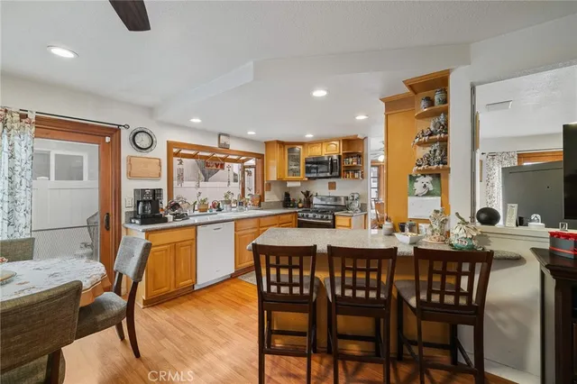 a kitchen with a dining table chairs and white cabinets