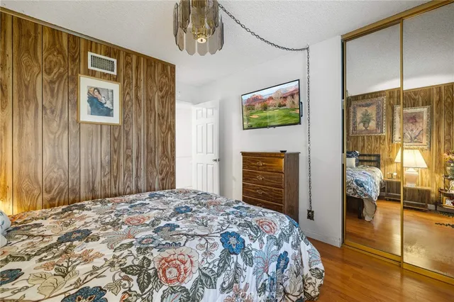 a bedroom with a bed and a flat tv screen