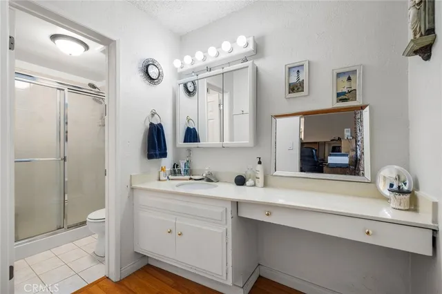 a bathroom with a sink a light fixture and a mirror