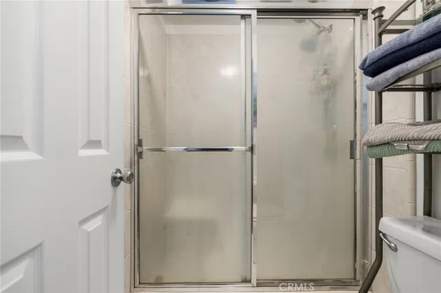 a bathroom with a glass shower door