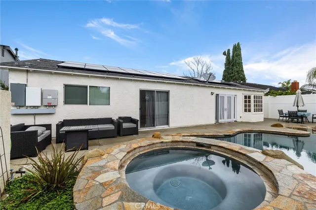 front view of a house with a yard and potted plants