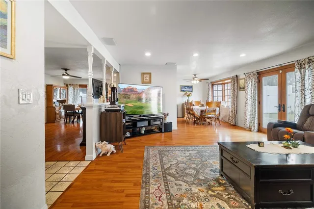 a living room with stainless steel appliances granite countertop furniture stove and kitchen view