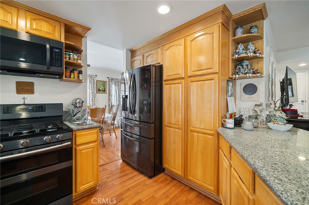 2158 Waldo Street Simi Valley, CA 93065 - Photo 8 of 46 a kitchen with stainless steel appliances granite countertop a refrigerator stove and microwave