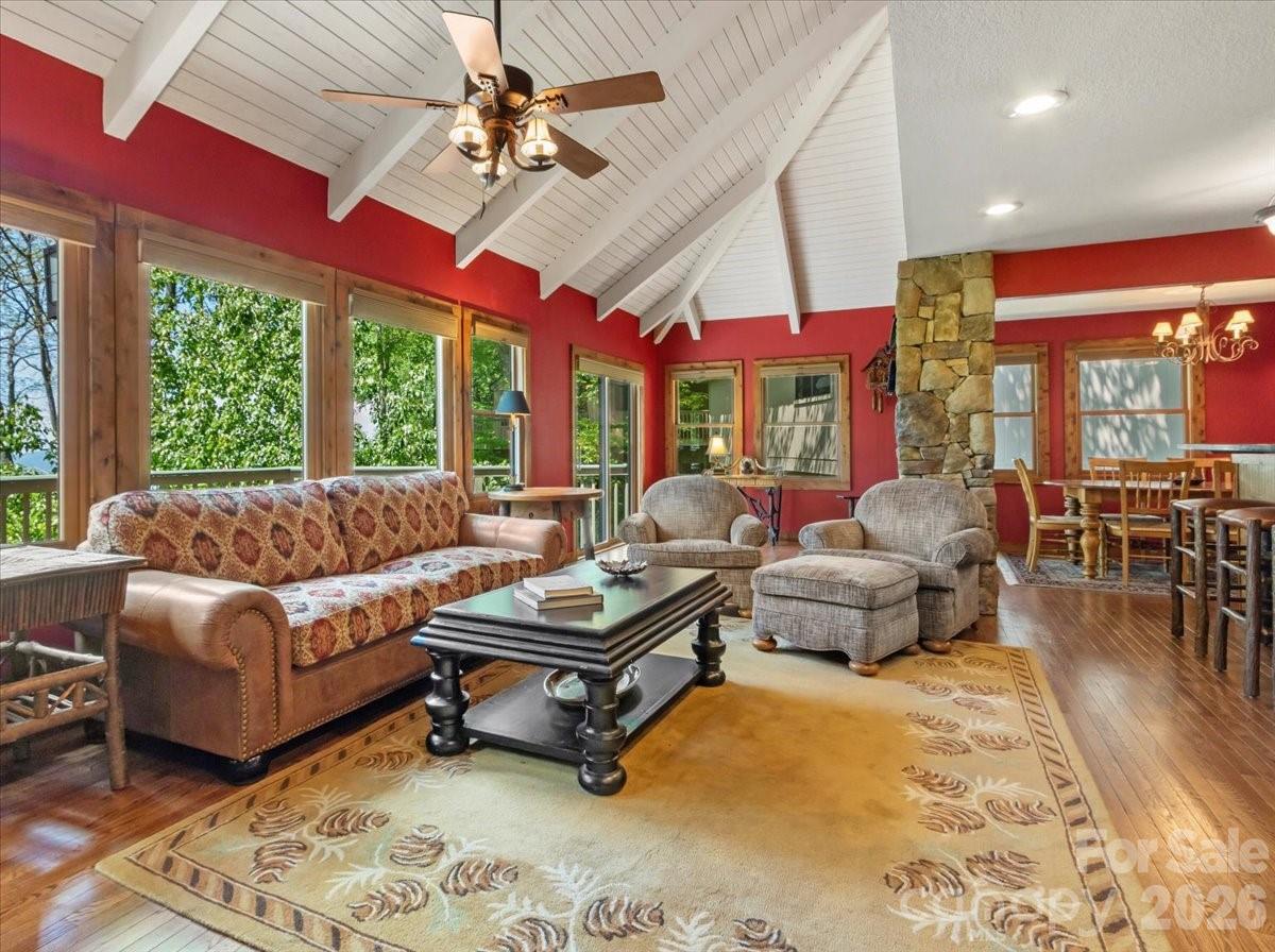 121 Ivy Ridge Road Burnsville, NC 28714 - Photo 5 of 48 a living room with furniture a flat screen tv and a large window