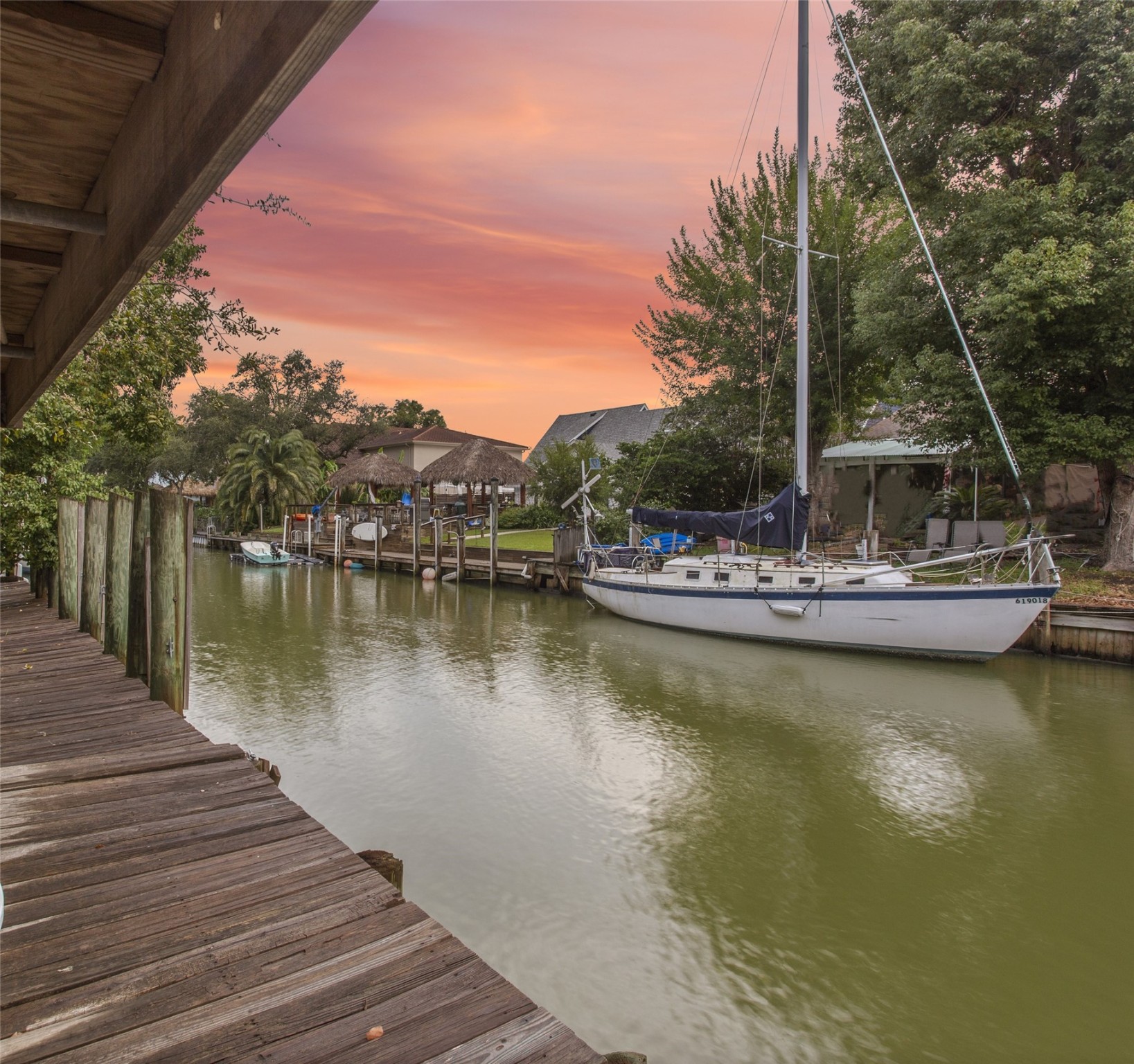 a view of a lake with boats and trees in the background