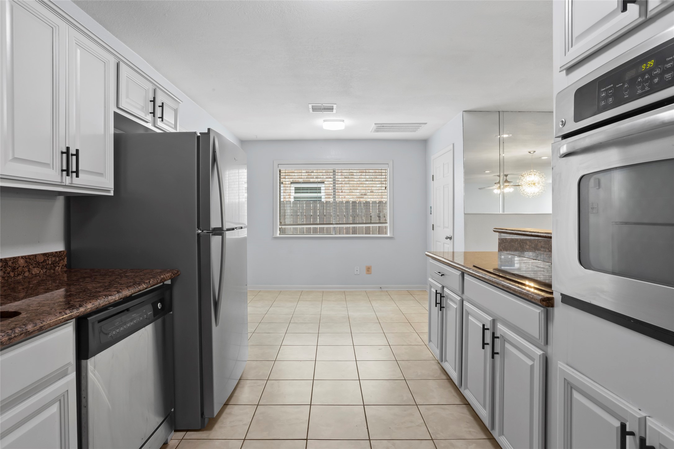 16 Harbor Lane Kemah, TX 77565 - Photo 11 of 31 a kitchen with granite countertop a refrigerator and a stove top oven