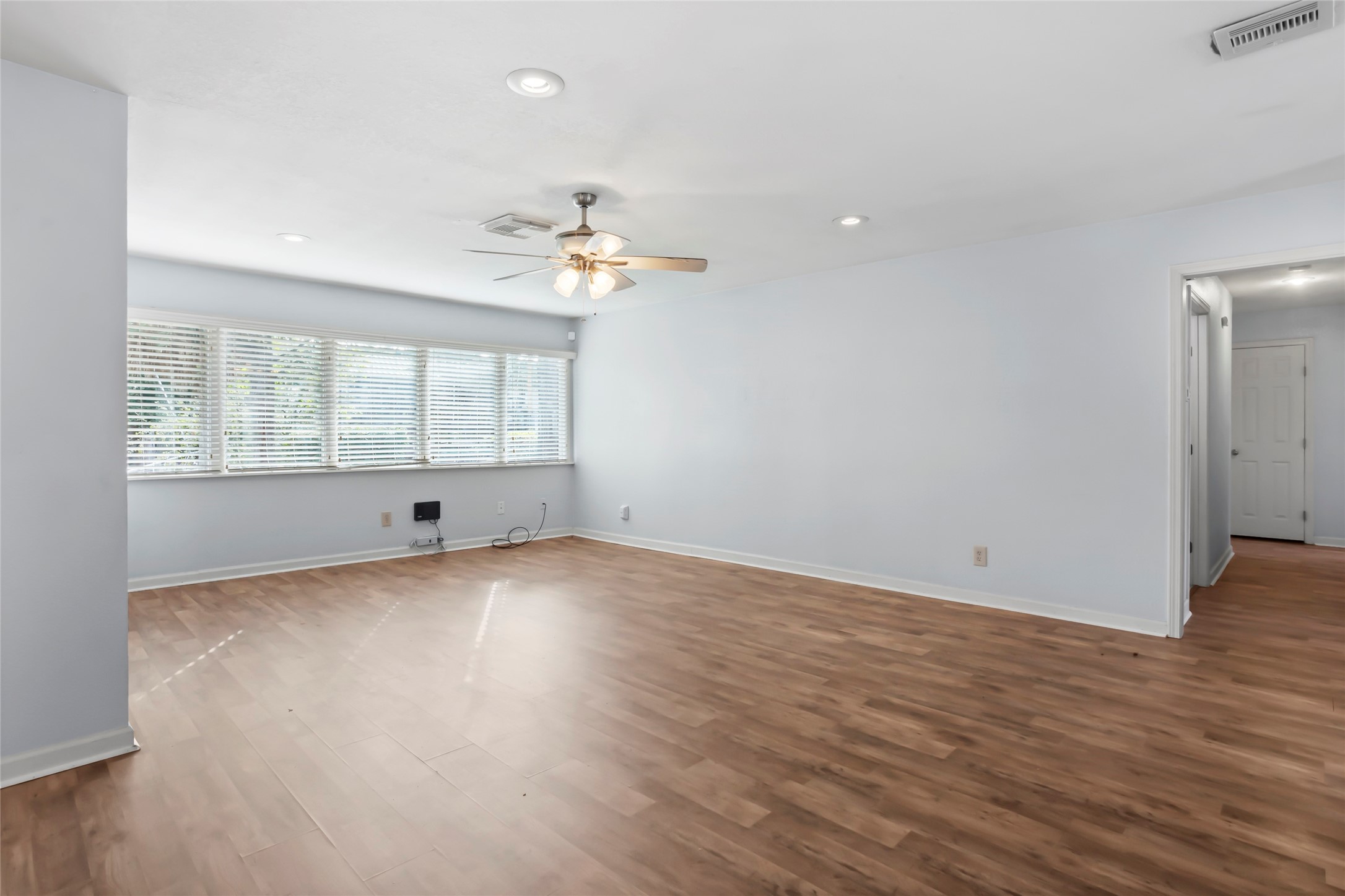 16 Harbor Lane Kemah, TX 77565 - Photo 8 of 31 an empty room with wooden floor and windows