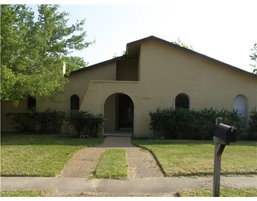 a backyard of a house with potted plants