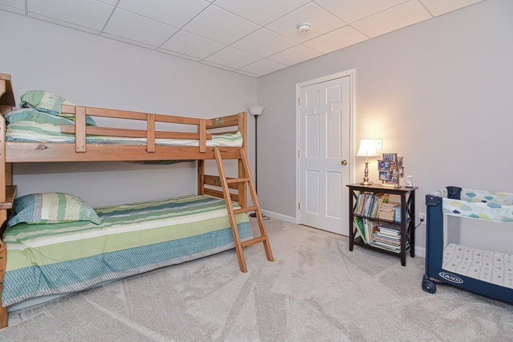 23 Winwood Road Sutton, MA 01590 - Photo 30 of 42 a bedroom with a bed and a dresser