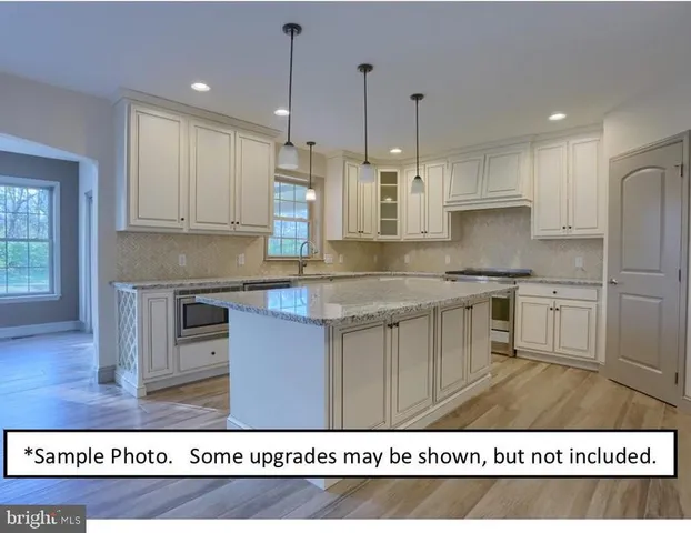 a kitchen with kitchen island granite countertop a stove a sink a refrigerator and a microwave