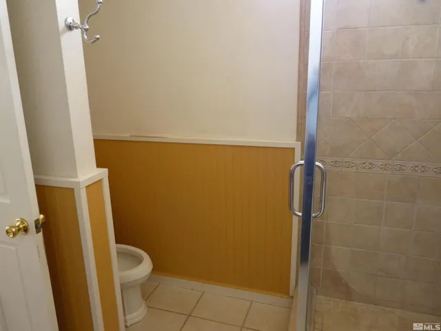 a bathroom with a toilet and shower