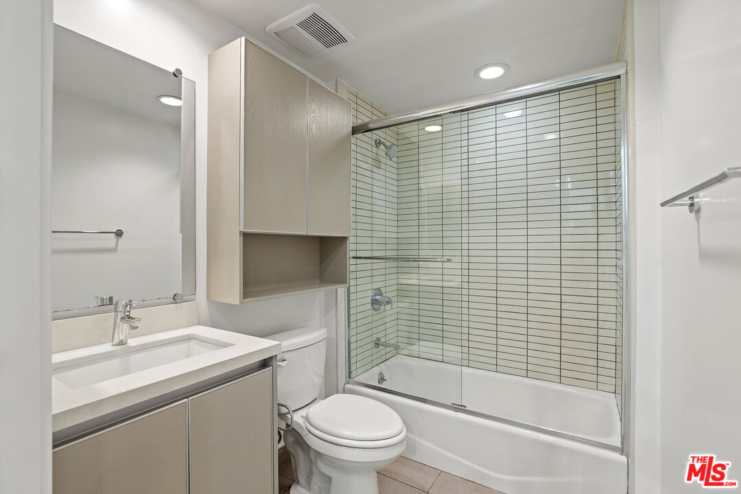 1411 Barry Avenue, Unit 306 Los Angeles, CA 90025 - Photo 11 of 14 a bathroom with a shower toilet sink and mirror