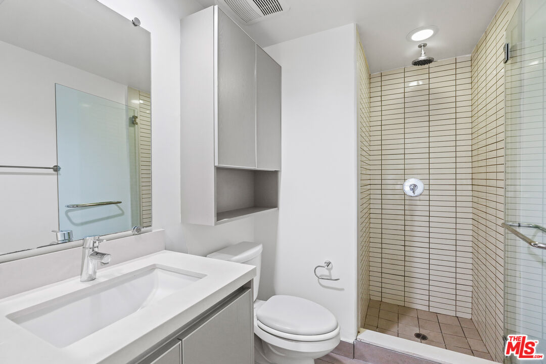 1411 Barry Avenue, Unit 306 Los Angeles, CA 90025 - Photo 13 of 14 a bathroom with a sink a toilet and shower