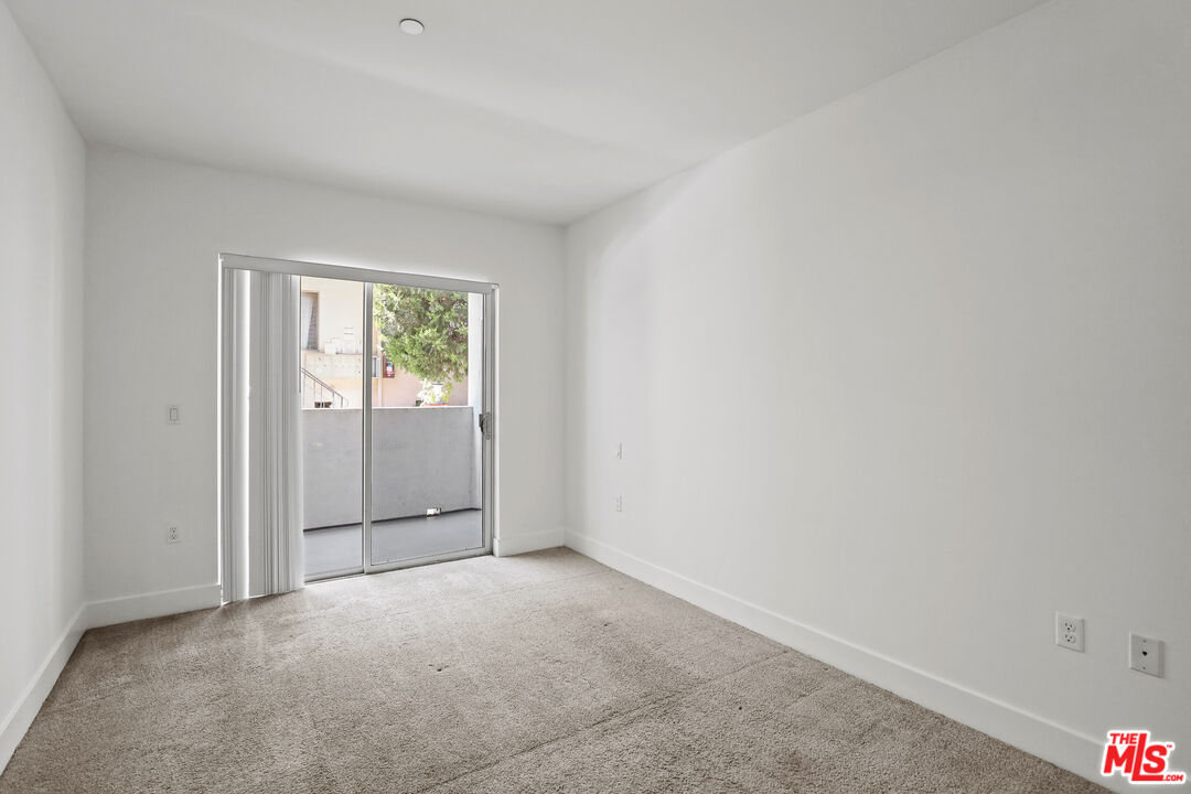 1411 Barry Avenue, Unit 306 Los Angeles, CA 90025 - Photo 6 of 14 an empty room with windows