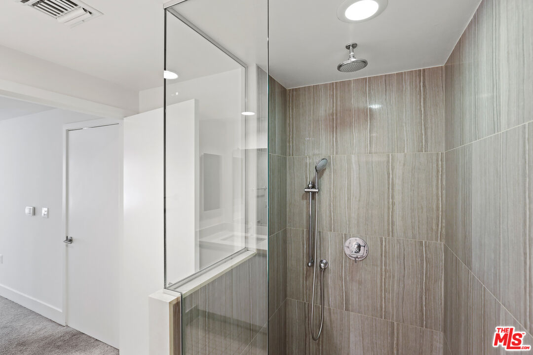1411 Barry Avenue, Unit 306 Los Angeles, CA 90025 - Photo 8 of 14 a bathroom with a shower and a glass door