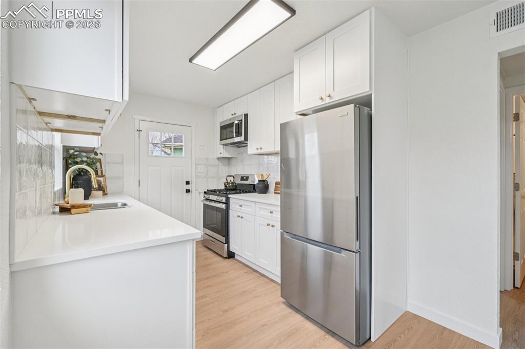 740 East Rio Grande Street Colorado Springs, CO 80903 - Photo 11 of 25 a kitchen with stainless steel appliances a refrigerator sink and stove