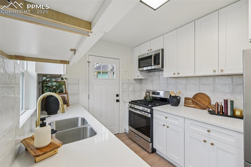 740 East Rio Grande Street Colorado Springs, CO 80903 - Photo 12 of 25 a kitchen with white cabinets and appliances