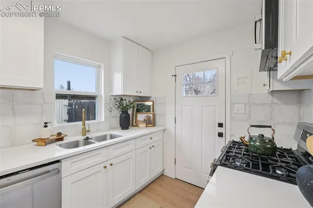 a kitchen with a sink and cabinets
