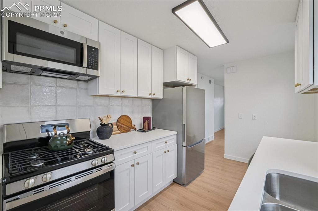 740 East Rio Grande Street Colorado Springs, CO 80903 - Photo 15 of 25 a kitchen with stainless steel appliances a stove microwave and refrigerator